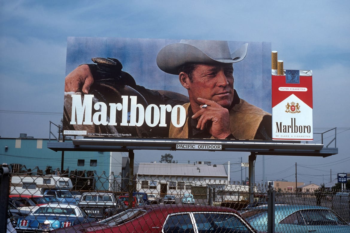 Roy on a Marlboro billboard above a parking lot.